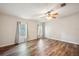 This bedroom offers a ceiling fan, neutral walls, wood-look floors, and natural light at 3319 Fox Ridge Blvd, Wesley Chapel, FL 33543