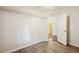 An empty bedroom with light wood floors, white walls, a hanging closet and a door to the connecting room at 3319 Fox Ridge Blvd, Wesley Chapel, FL 33543