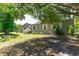 Inviting exterior view of a home with a well-maintained lawn and mature trees providing shade at 3319 Fox Ridge Blvd, Wesley Chapel, FL 33543