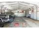 Large metal garage with ample space for vehicles and storage, featuring a workbench and natural light at 3319 Fox Ridge Blvd, Wesley Chapel, FL 33543
