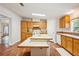Spacious kitchen with wood cabinets, tile countertops, and large center island for entertaining at 3319 Fox Ridge Blvd, Wesley Chapel, FL 33543
