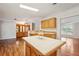 Open-concept kitchen with an island featuring light countertops, natural-toned cabinetry, and wood-style floors at 3319 Fox Ridge Blvd, Wesley Chapel, FL 33543