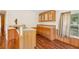 Functional kitchen with breakfast bar, hardwood floors, tile countertops and natural wood cabinets at 3319 Fox Ridge Blvd, Wesley Chapel, FL 33543