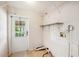 A laundry room with a white door and shelves at 3319 Fox Ridge Blvd, Wesley Chapel, FL 33543