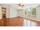 Spacious living room with hardwood floors, large windows, and a ceiling fan at 3319 Fox Ridge Blvd, Wesley Chapel, FL 33543