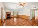 Cozy living room features wood-burning fireplace, hardwood floors, and natural light at 3319 Fox Ridge Blvd, Wesley Chapel, FL 33543
