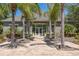 The clubhouse is surrounded by palm trees and lush landscaping at 3583 Wembley Way # 101, Palm Harbor, FL 34685