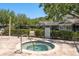 Community hot tub spa with safety railing and surrounding fence with posted rules at 3583 Wembley Way # 101, Palm Harbor, FL 34685