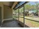 View from the screened patio of the lawn and neighboring buildings at 3583 Wembley Way # 101, Palm Harbor, FL 34685