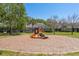 Community playground with colorful equipment in a grassy setting surrounded by mature trees at 3583 Wembley Way # 101, Palm Harbor, FL 34685