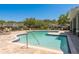 Community pool with plenty of lounge chairs and green landscaping at 3583 Wembley Way # 101, Palm Harbor, FL 34685