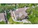 Aerial view of a home by the lake with a well-manicured lawn at 3611 Pine Knot Dr, Valrico, FL 33596