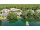 Overhead view of homes by a lake with a fountain, surrounded by lush trees at 3611 Pine Knot Dr, Valrico, FL 33596