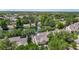 Aerial shot showcases the neighborhood with lush trees, a pond, and well-manicured lawns at 3611 Pine Knot Dr, Valrico, FL 33596