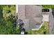 Aerial view of a home with a well-maintained roof, green lawn, and mature trees at 3611 Pine Knot Dr, Valrico, FL 33596
