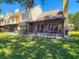 Spacious backyard featuring a screened-in patio, manicured lawn, and mature trees, perfect for outdoor living at 3611 Pine Knot Dr, Valrico, FL 33596