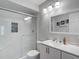 Bathroom showcasing a glass-enclosed shower with modern fixtures and a vanity with ample lighting at 3611 Pine Knot Dr, Valrico, FL 33596