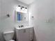 Bathroom with a modern vanity, decorative mirror, and updated lighting fixtures at 3611 Pine Knot Dr, Valrico, FL 33596