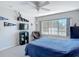 Bedroom boasting a large window with lake views, a ceiling fan, and wall-mounted decor at 3611 Pine Knot Dr, Valrico, FL 33596