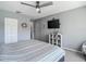 Bedroom boasts a TV, shelf decor, and a comfortable bed, perfect for relaxation at 3611 Pine Knot Dr, Valrico, FL 33596