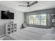 Bedroom featuring a large window with a water view, TV, and comfortable seating area at 3611 Pine Knot Dr, Valrico, FL 33596