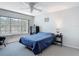 Bedroom featuring carpet floors, a ceiling fan, and a serene view of the water from the window at 3611 Pine Knot Dr, Valrico, FL 33596