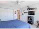 Cozy bedroom includes a ceiling fan, television, and a spacious closet at 3611 Pine Knot Dr, Valrico, FL 33596