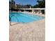 Large community pool with ample lounge chairs and covered patio area at 3611 Pine Knot Dr, Valrico, FL 33596