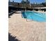 Community pool with lounge seating, umbrellas, and clear water at 3611 Pine Knot Dr, Valrico, FL 33596