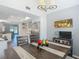 View of dining room open to kitchen featuring hardwood floors and modern lighting at 3611 Pine Knot Dr, Valrico, FL 33596