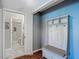 Entryway with decorative storage bench and a view into the bright, updated bathroom at 3611 Pine Knot Dr, Valrico, FL 33596