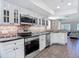 Updated kitchen with white cabinets, granite countertops and stainless appliances open to living space at 3611 Pine Knot Dr, Valrico, FL 33596