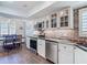 Charming kitchen with white cabinetry, stainless steel appliances, and a cozy dining area at 3611 Pine Knot Dr, Valrico, FL 33596