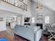 Open concept living room showing seamless flow to the kitchen and hardwood floors at 3611 Pine Knot Dr, Valrico, FL 33596