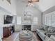 Bright living room boasts a fireplace, ceiling fan, and hardwood floors at 3611 Pine Knot Dr, Valrico, FL 33596