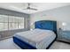 Calming main bedroom with neutral color scheme, large window view, ceiling fan and carpet at 3611 Pine Knot Dr, Valrico, FL 33596