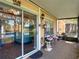 Enclosed porch with outdoor seating, sliding glass door, and views of the lake at 3611 Pine Knot Dr, Valrico, FL 33596