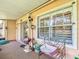 Enclosed porch with outdoor seating and views of the surrounding landscape at 3611 Pine Knot Dr, Valrico, FL 33596