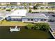 Scenic aerial view of commercial building with dock, parking lot, and waterfront community along canal at 4256 Rudder Way, New Port Richey, FL 34652