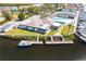 Beautiful aerial view of the Yacht Club featuring a pool, tennis courts, boat docks, and lush landscaping at 4256 Rudder Way, New Port Richey, FL 34652