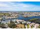 Community aerial view featuring waterfront homes, canals, tennis court, pool, and lush landscaping at 4256 Rudder Way, New Port Richey, FL 34652