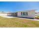 This backyard showcases green grass, mature landscaping, a white privacy fence, and access to a screened in patio at 4256 Rudder Way, New Port Richey, FL 34652