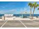 Beachfront picnic area with sheltered tables offering serene ocean views and nearby parking at 4256 Rudder Way, New Port Richey, FL 34652