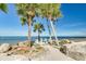 Quaint beach view showing access to water with nearby shaded seating at 4256 Rudder Way, New Port Richey, FL 34652