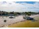 The beach features a sandy shore, palm trees, shelters, and calm, inviting waters at 4256 Rudder Way, New Port Richey, FL 34652