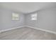 This bedroom has neutral walls, light-colored floors and two windows at 4256 Rudder Way, New Port Richey, FL 34652
