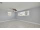 This bedroom has neutral walls, light-colored floors and a ceiling fan at 4256 Rudder Way, New Port Richey, FL 34652