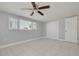 This bedroom features neutral walls, light-colored floors and a ceiling fan at 4256 Rudder Way, New Port Richey, FL 34652