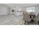 Open dining area showcasing a table setting, breakfast bar, stainless steel appliances, and sliding glass doors at 4256 Rudder Way, New Port Richey, FL 34652