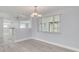 Open dining room with wood-look tile and a view of the kitchen at 4256 Rudder Way, New Port Richey, FL 34652